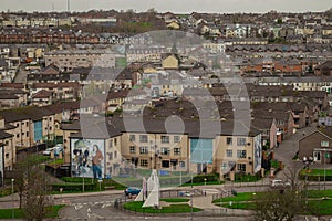 Panorama of Derry or Londonderry on a cloudy day viewed from the city walls. Green panorama of the city, residental houses visible