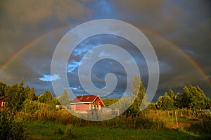 Panorama of double rainbow over village in summer, Moscow region, Russia