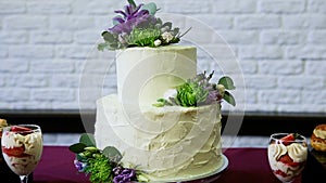 Panorama down on two levels white cake decorated with flowers