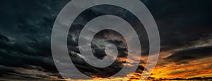 Panorama of a Dramatic sky at stormy sunset. Dark clouds before a thunder storm