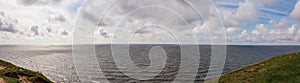 Panorama of dramatic summer cloud sky above the baltic sea seen from Ales stenar in SkÃÂ¥ne Scania Sweden photo