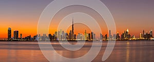 Panorama of Dubai Business Bay skyline at night after sunset.