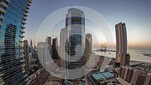 Panorama of the Dubai Marina and JBR area and the famous Ferris Wheel aerial day to night timelapse