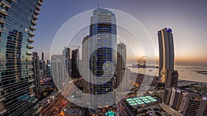 Panorama of the Dubai Marina and JBR area and the famous Ferris Wheel aerial day to night timelapse