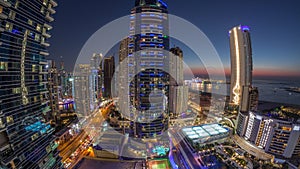 Panorama of the Dubai Marina and JBR area and the famous Ferris Wheel aerial day to night timelapse