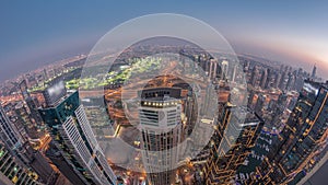 Panorama of Dubai Marina with JLT skyscrapers and golf course day to night timelapse, Dubai, United Arab Emirates.