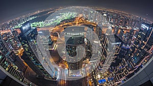 Panorama of Dubai Marina with JLT skyscrapers and golf course day to night timelapse, Dubai, United Arab Emirates.