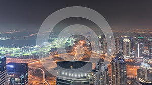 Panorama of Dubai Marina with JLT skyscrapers and golf course night timelapse, Dubai, United Arab Emirates.