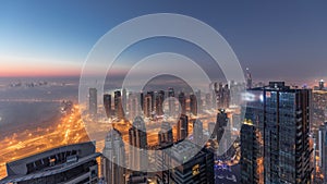 Panorama of Dubai Marina with JLT skyscrapers and golf course night to day timelapse, Dubai, United Arab Emirates.