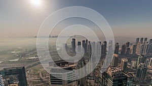 Panorama of Dubai Marina with JLT skyscrapers and golf course during sunrise timelapse, Dubai, United Arab Emirates.