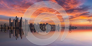 Panorama of Dubai Marina skyline at sunset with a beautiful dramatic sky