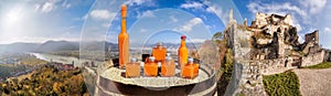 Panorama of Durnstein castle with apricots drinks on barrel during spring time in Wachau, Austria, Unesco world heritage site