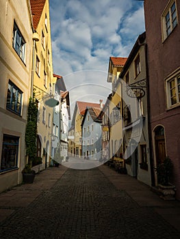 Panorama of empty cobblestone alley pedestrian street historic old town colorful facade Fussen Fuessen Bavaria Germany