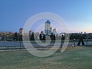 Panorama of the evening metropolis. Skyscrapers and modern buildings. Park zone.