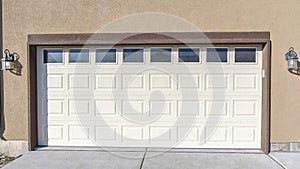 Panorama Exterior of an attached garage of a two-storey house with concrete driveway