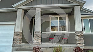 Panorama Facade of home with view of the front porch yard outdoor stairs and garage door