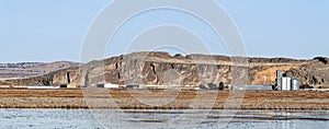 Panorama of farms and a grain elevator below the cliffs across Tule Lake in California, USA