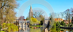 Panorama with Flemish style house reflecting in Minnewater lake, Bruges, Belgium