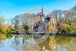 Panorama with Flemish style house reflecting in Minnewater lake, Bruges, Belgium