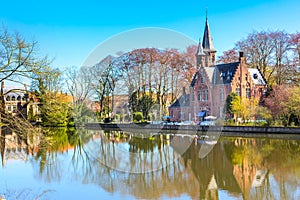 Panorama with Flemish style house reflecting in Minnewater lake, Bruges, Belgium