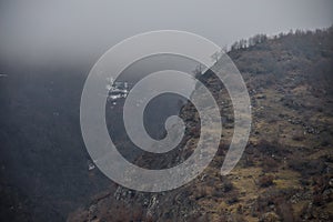 Panorama of the foggy winter landscape in the mountains with snow and rocks, Azerbaijan, Lahic, Big Caucasus