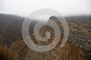 Panorama of the foggy winter landscape in the mountains with snow and rocks, Azerbaijan, Lahic, Big Caucasus