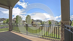 Panorama frame Balcony overlooking the yard houses and blue sky with clouds on a sunny day