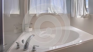 Panorama frame Bathroom interior with close up view of the gleaming built in bathtub