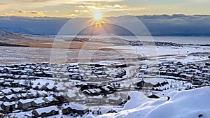Panorama frame Beautiful sunrise in Draper Utah with snowy hills lake and houses in winter