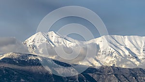 Panorama frame Beautiful view of a mountain with its peak covered with sunlit white snow
