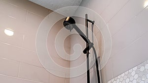 Panorama frame Black round shower head and handle inside the walk in bathroom shower stall