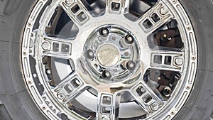 Panorama frame Close up of the black rubber tire of an off roading truck with shiny chrome mags