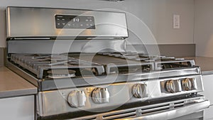 Panorama frame Close up of the cooktop of a range under wall mounted microwave inside a kitchen