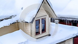 Panorama frame Close up of Park City Utah home with icicles and thick layer of snow on the roof