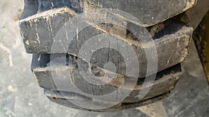 Panorama frame Details of the thick and heavy duty wheel of a yellow construction machine