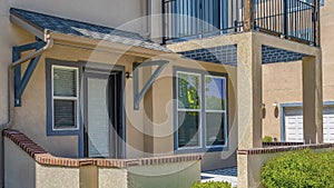 Panorama frame Facade of home with pathway that leads to the porch and glass paned front door