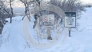Panorama frame Foot path and signages at the snow covered slope of Wasatch Mountains in winter