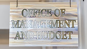 Panorama frame Office Of Management And Budget sign hanging on decrative wrought iron hanger
