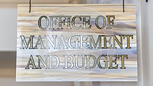 Panorama frame Office Of Management And Budget sign hanging on decrative wrought iron hanger photo