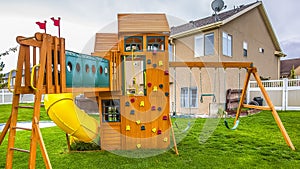 Panorama frame Playground structure with slide swings playhouse tower and climbing wall