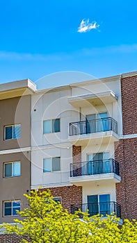 Panorama frame Residential building featuring red brick exterior wall and small balconies