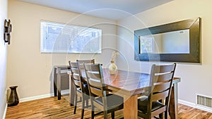 Panorama frame Small dining area with wood flooring, rustic wooden table set and decorative pot on the table