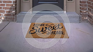 Panorama frame Wreath and doormat on the front door with sidelights and transom window photo