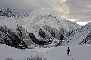 Panorama of French Alps with mountain ranges covered in snow and clouds in winter