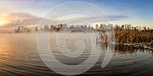 Panorama of frosty morning on the lake with fog, Russia, Ural, November