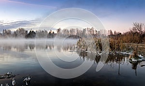 Panorama of frosty morning on the lake with fog, Russia, Ural, November