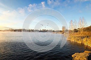 Panorama of frosty morning on the lake with fog, Russia, Ural, November