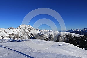 Panorama of Gaital alps with the highest mountain Eggenkofel on the left. Blue sky with ideal snow condition means perfect ski