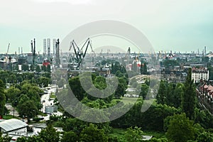 Panorama of the Gdansk shipyard with its distinctive cranes and ships being built and repaired.