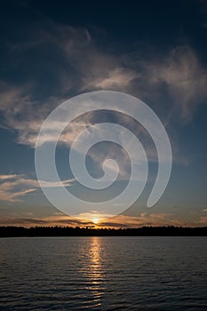 Panorama of a gorgeous sunset at a forest lake